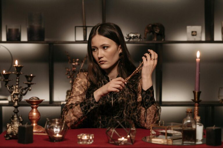 A woman in leopard print sits in a candlelit setting, exuding mystery and magic.